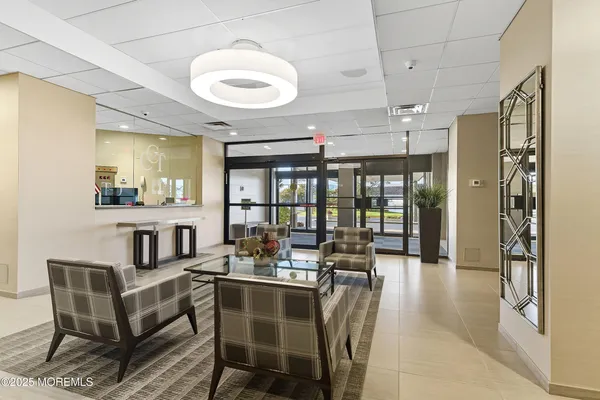 a dining room with furniture and a floor to ceiling window
