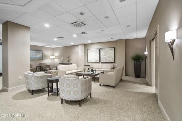 a living room with fireplace furniture and a large window