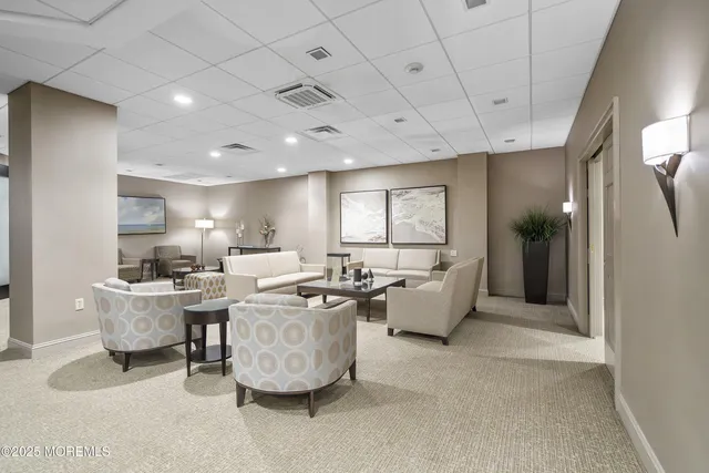 a living room with fireplace furniture and a large window