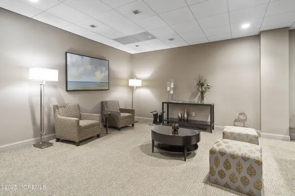 a living room with furniture and a lamp