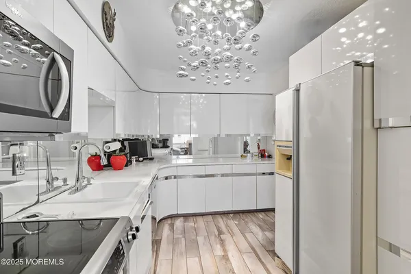 a kitchen with a sink stove and refrigerator