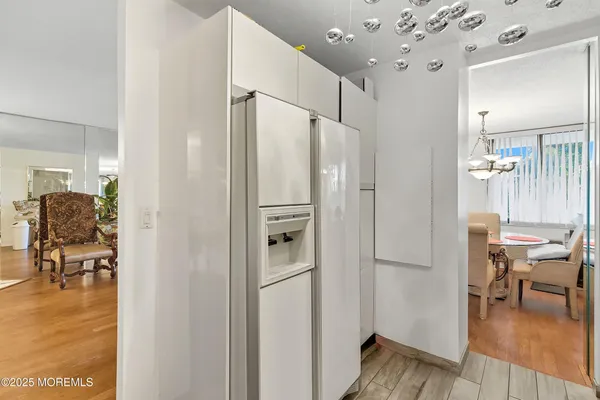 a dining room with furniture a chandelier and wooden floor