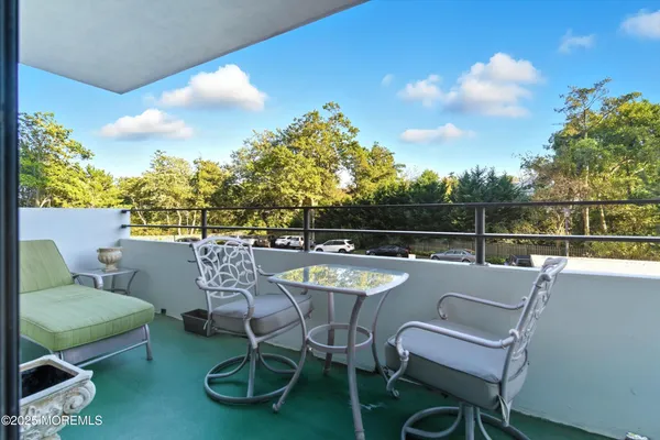 a dining room with furniture a chandelier and wooden floor