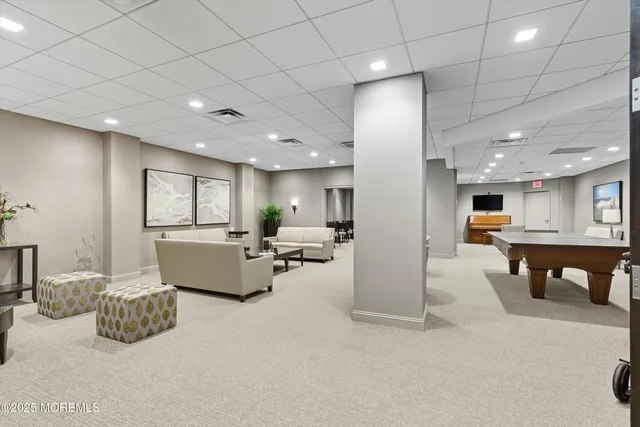 a living room with furniture a dining table and chairs