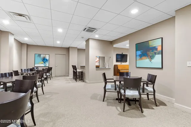 a large white kitchen with a table and chairs