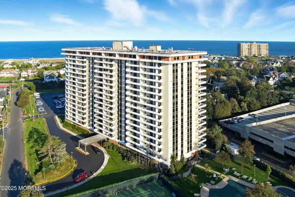 a view of a balcony with chairs and a potted plant