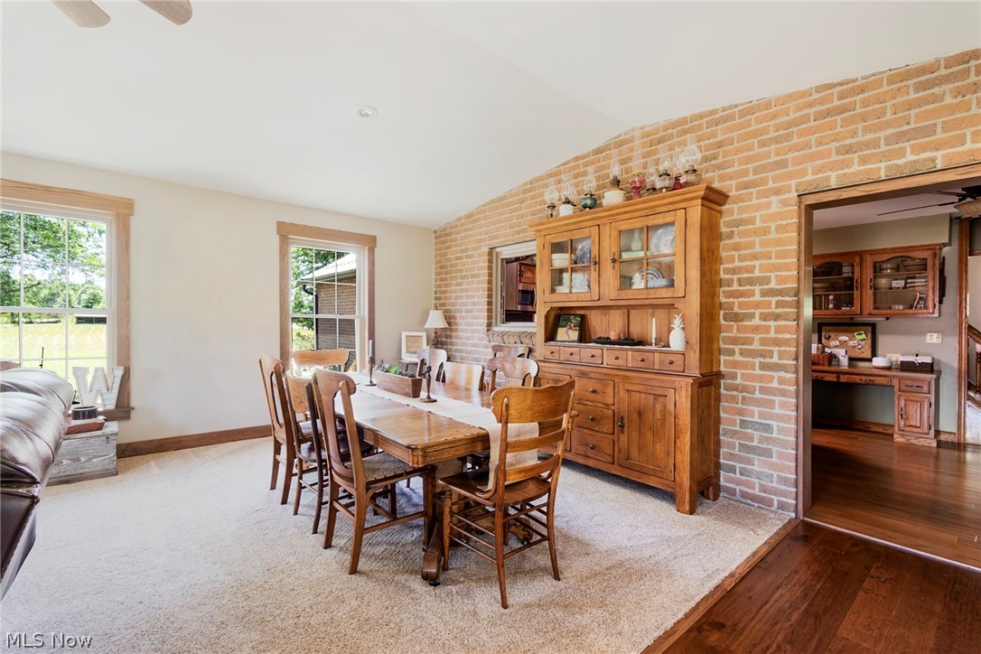 11711 Bandy Road Alliance, OH 44601 - Photo 32 of 50 Dining area featuring hardwood / wood-style flooring, a healthy amount of sunlight, vaulted ceiling, and ceiling fan