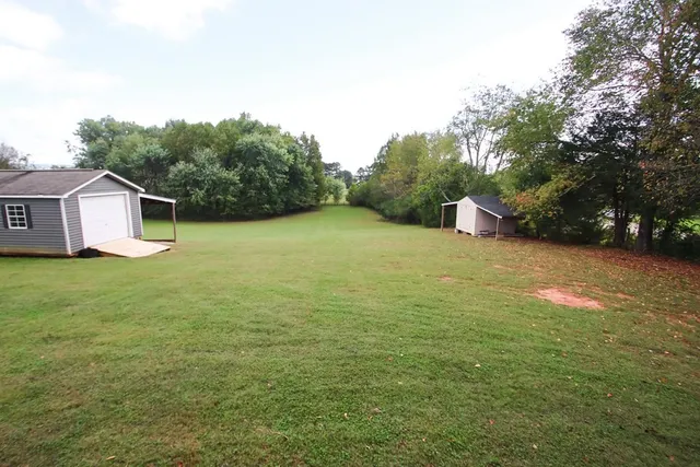 a backyard of a house with lots of green space