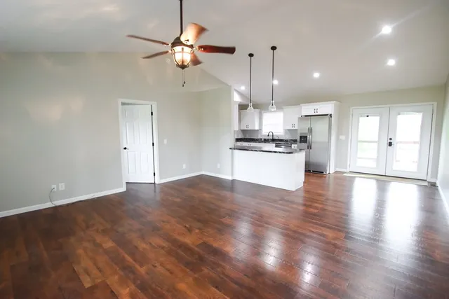 a kitchen with stainless steel appliances granite countertop a refrigerator a sink and a stove