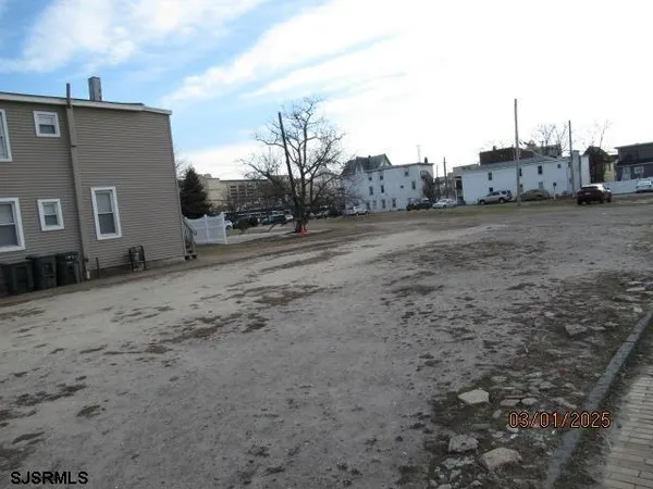a view of a dirt road with a building