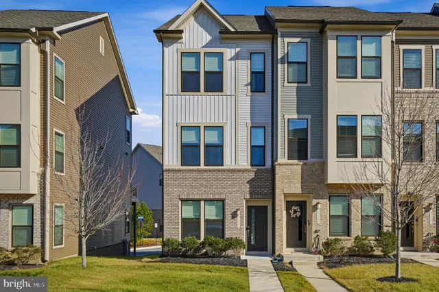 a front view of a residential apartment building with a yard
