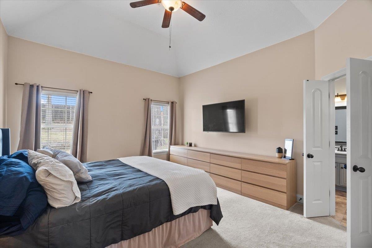 4740 Wellsgate Point Bartlett, TN 38135 - Photo 14 of 36 a bedroom with a bed and a flat screen tv