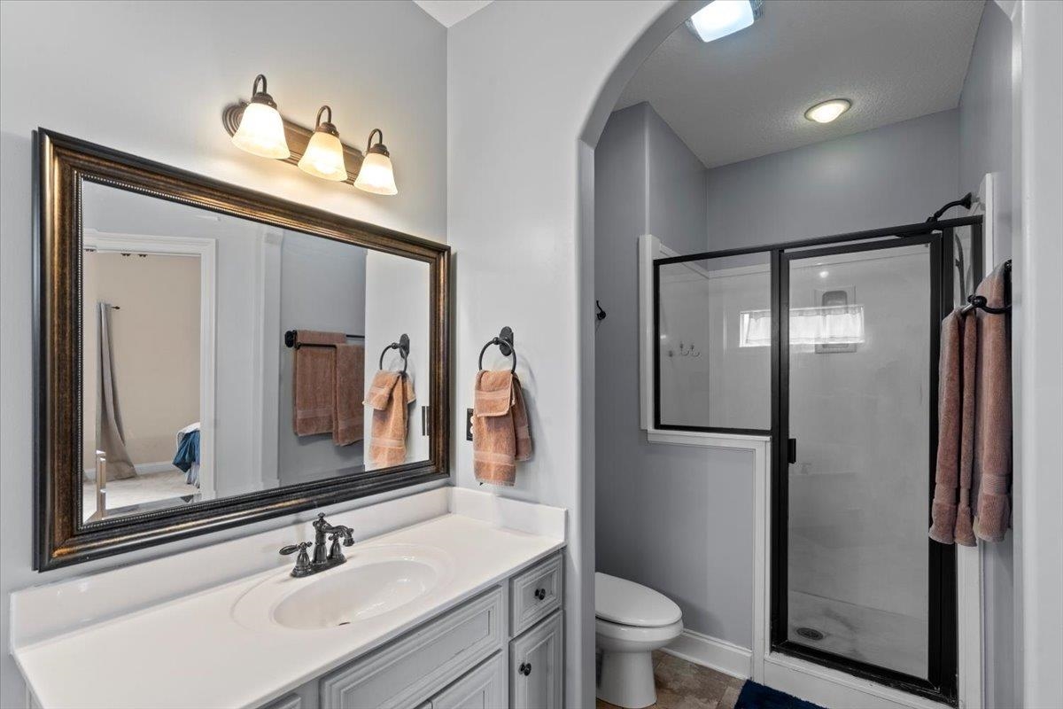 4740 Wellsgate Point Bartlett, TN 38135 - Photo 16 of 36 a bathroom with a sink vanity mirror and toilet