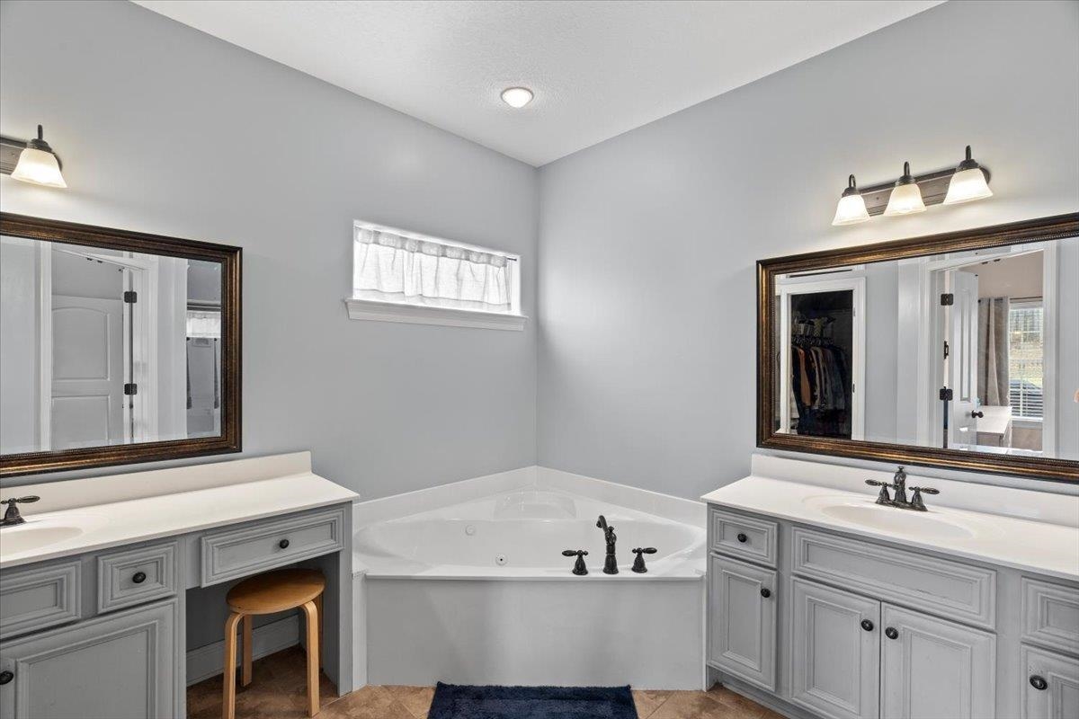 4740 Wellsgate Point Bartlett, TN 38135 - Photo 17 of 36 a bathroom with a tub sink and mirror