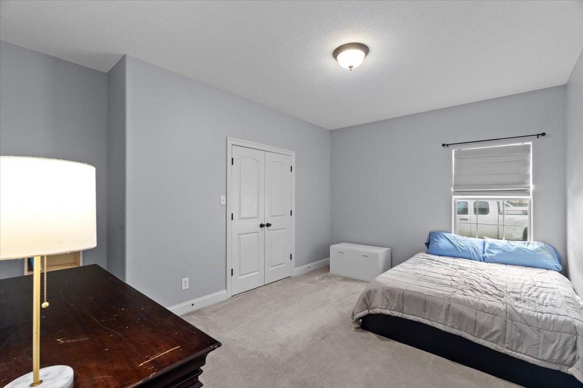 4740 Wellsgate Point Bartlett, TN 38135 - Photo 22 of 36 a bedroom with a bed and a lamp