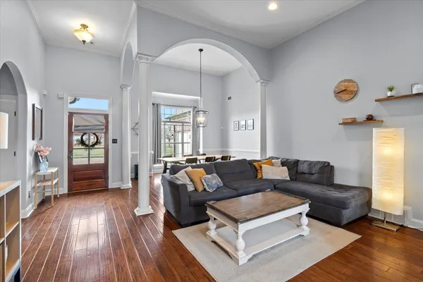 a view of a dining room with furniture and wooden floor