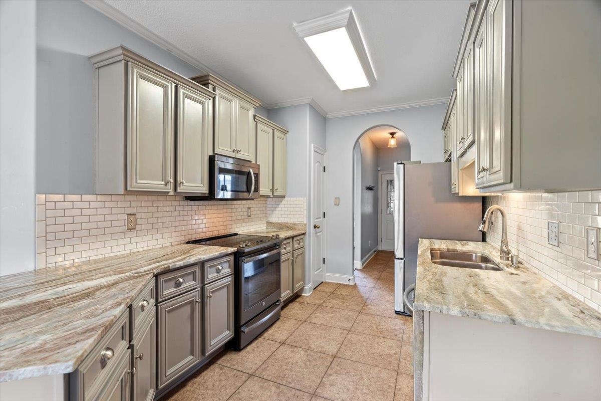 4740 Wellsgate Point Bartlett, TN 38135 - Photo 10 of 36 a kitchen with stainless steel appliances granite countertop a sink and a stove