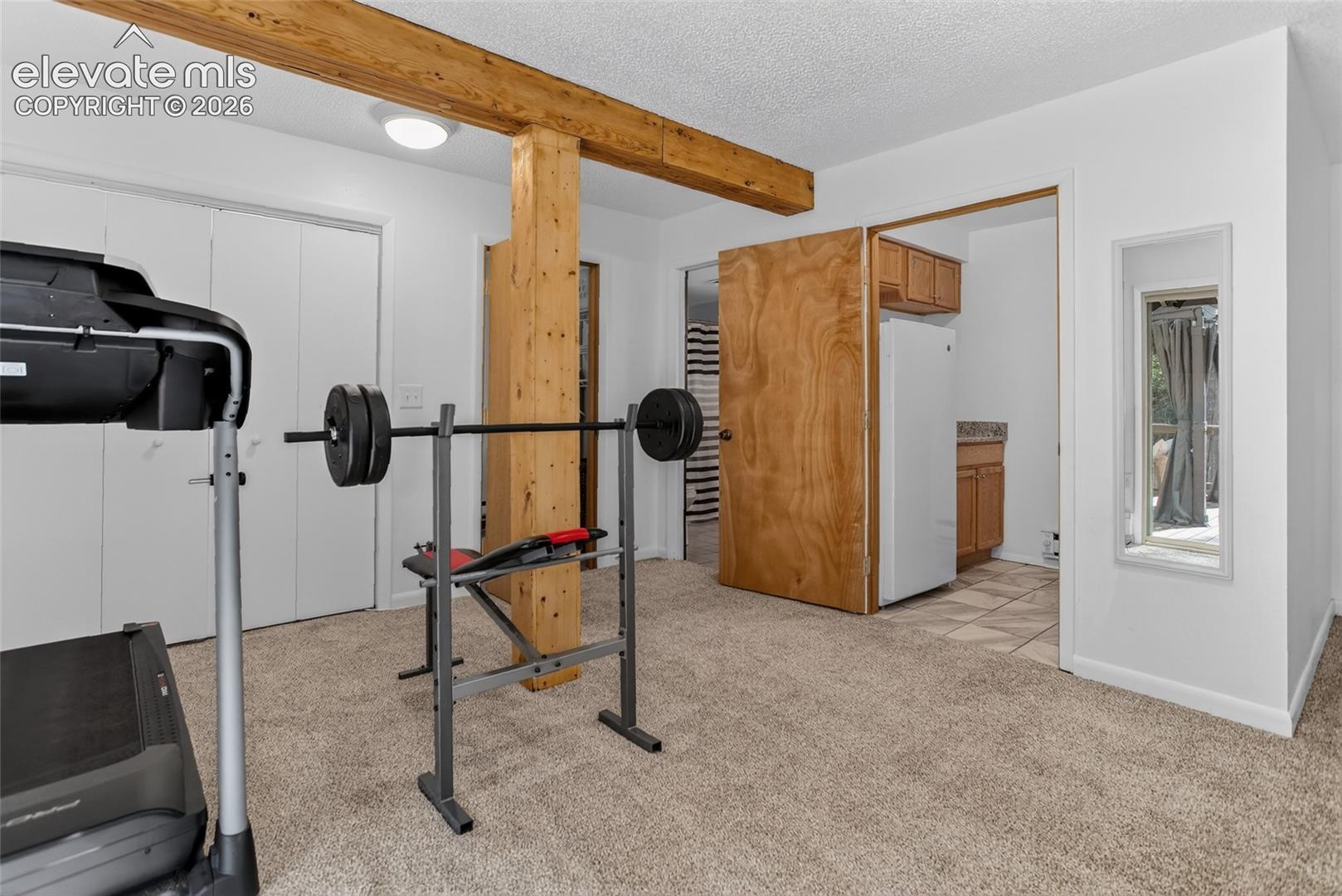 5145 Neeper Valley Road Manitou Springs, CO 80829 - Photo 36 of 49 Lower level flex room and view of wet bar area.