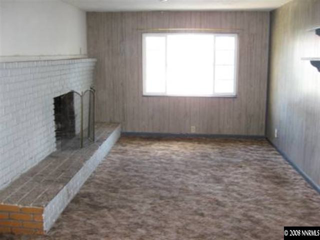 1450 Castle Way Reno, NV 89512 - Photo 2 of 4 an empty room with a fireplace and windows