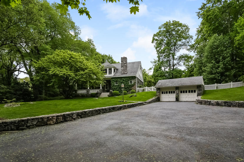 17 Goodwives River Road Darien, CT 06820 - Photo 1 of 51 a view of a house with a yard and table and chairs under an umbrella