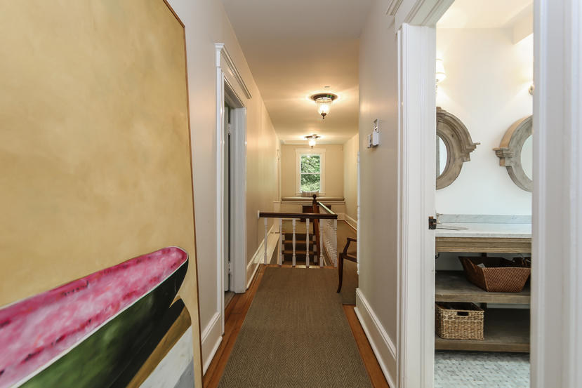 17 Goodwives River Road Darien, CT 06820 - Photo 22 of 51 a view of a hallway and a livingroom with furniture