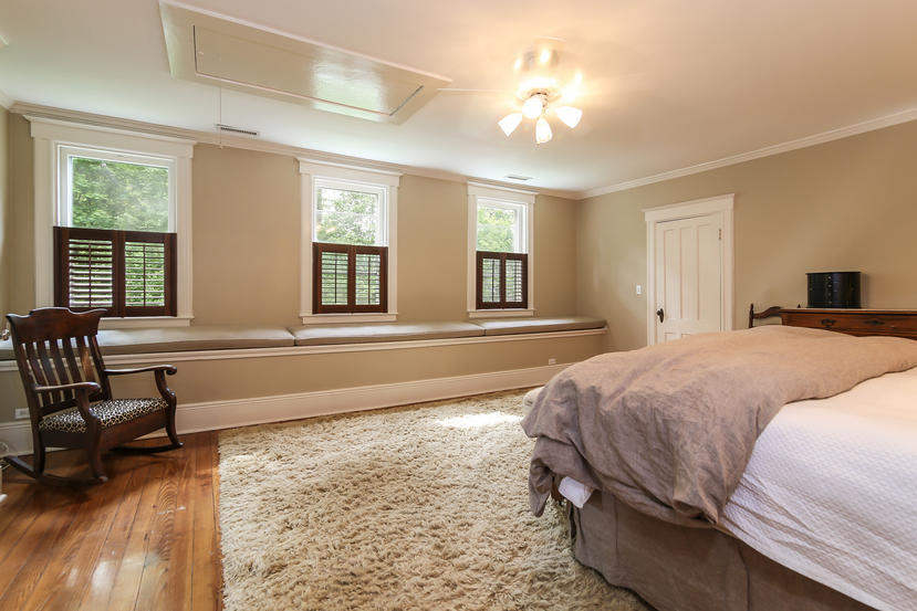 17 Goodwives River Road Darien, CT 06820 - Photo 24 of 51 a spacious bedroom with a bed a couch and large windows