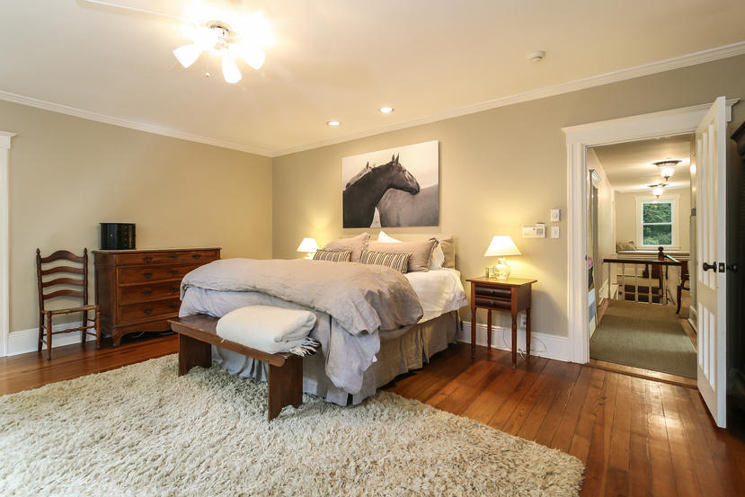 17 Goodwives River Road Darien, CT 06820 - Photo 25 of 51 a bedroom with a bed and a chandelier