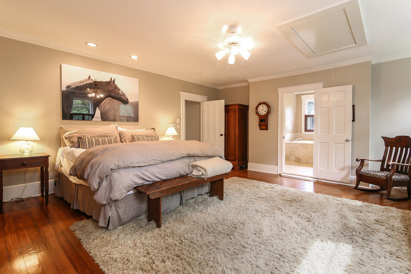 17 Goodwives River Road Darien, CT 06820 - Photo 26 of 51 a spacious bedroom with a bed and a chandelier