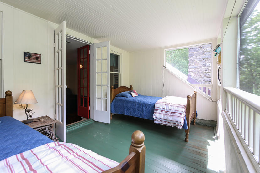 17 Goodwives River Road Darien, CT 06820 - Photo 32 of 51 a bedroom with a bed and wooden floor