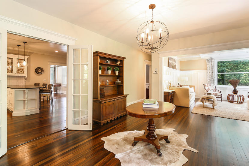 17 Goodwives River Road Darien, CT 06820 - Photo 5 of 51 a dining room with wooden floor a chandelier a wooden table and chairs