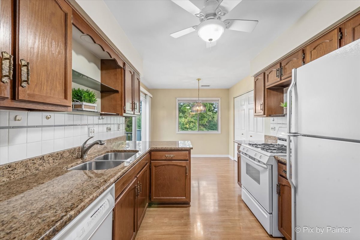 -n021 Windermere Road, Unit 405 Winfield, IL 60190 - Photo 11 of 50 a kitchen with stainless steel appliances granite countertop a sink stove and refrigerator