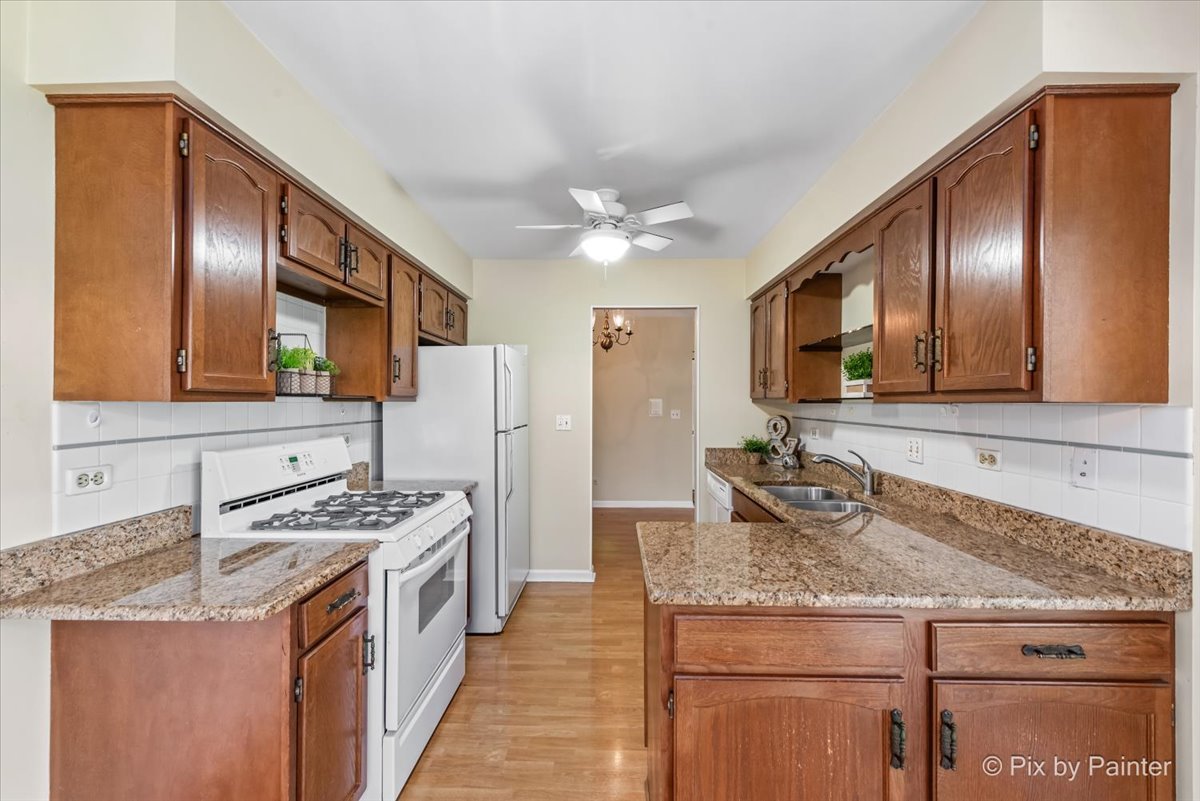 -n021 Windermere Road, Unit 405 Winfield, IL 60190 - Photo 13 of 50 a kitchen with stainless steel appliances granite countertop a sink stove and refrigerator