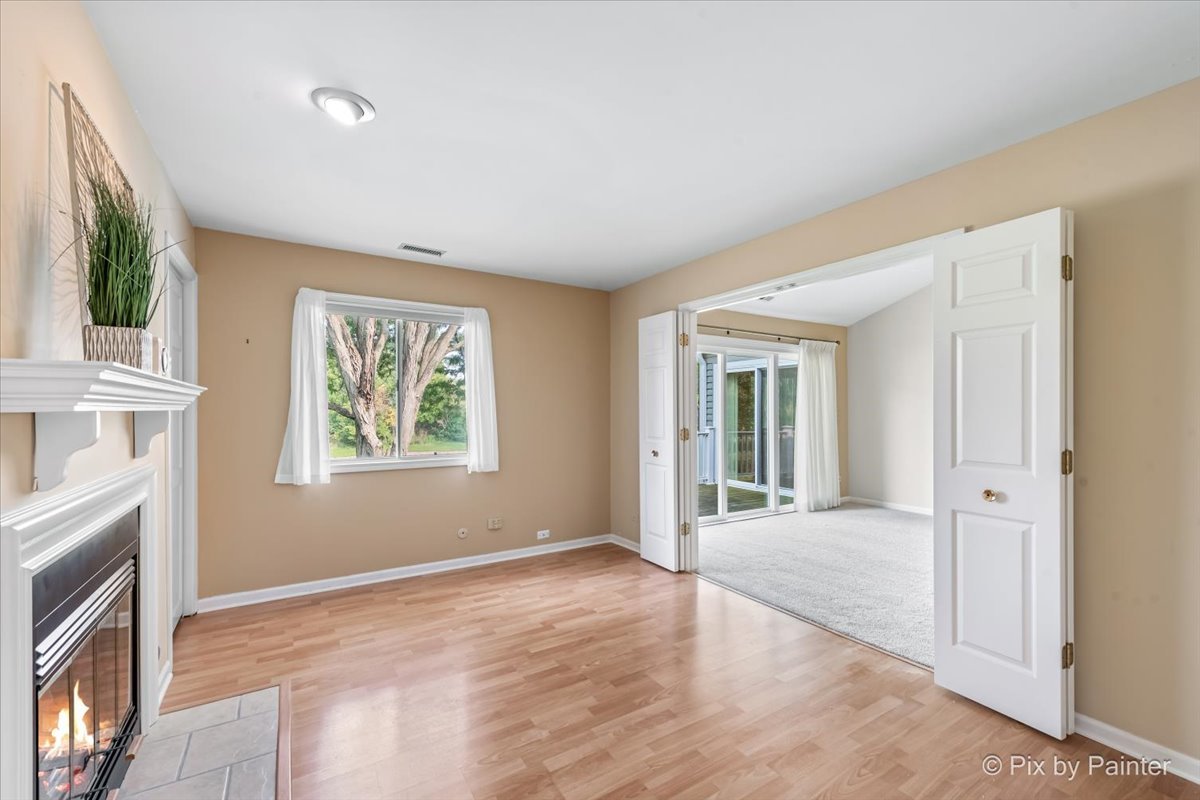 -n021 Windermere Road, Unit 405 Winfield, IL 60190 - Photo 15 of 50 an empty room with windows and fireplace