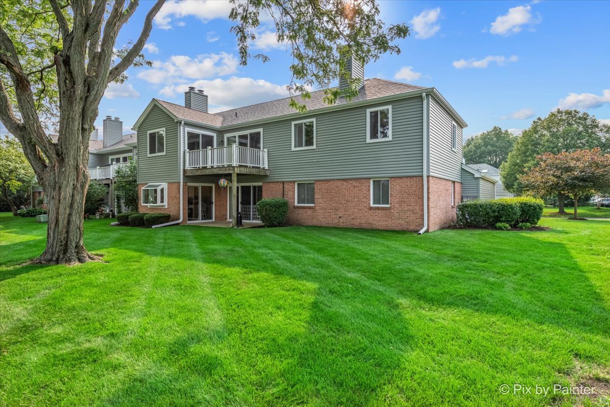 -n021 Windermere Road, Unit 405 Winfield, IL 60190 - Photo 41 of 50 a front view of a house with a garden and plants