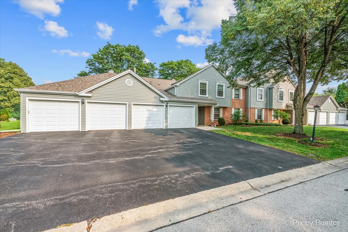 -n021 Windermere Road, Unit 405 Winfield, IL 60190 - Photo 49 of 50 a front view of a house with a garden