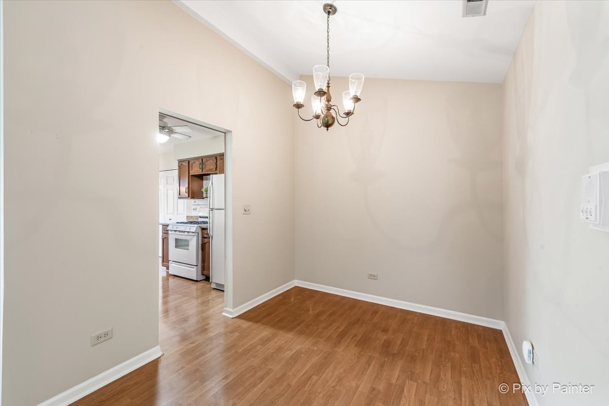 -n021 Windermere Road, Unit 405 Winfield, IL 60190 - Photo 9 of 50 wooden floor in an empty room with a window