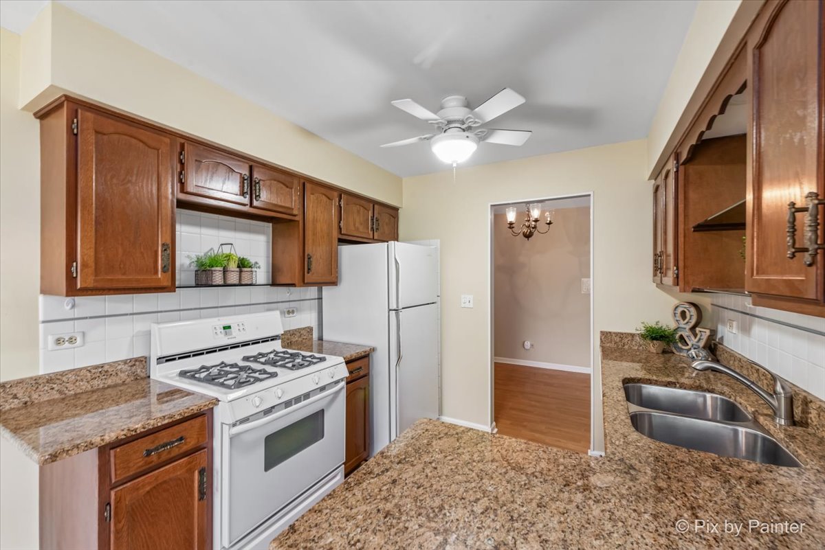 -n021 Windermere Road, Unit 405 Winfield, IL 60190 - Photo 10 of 50 a kitchen with stainless steel appliances granite countertop a stove refrigerator and dishwasher