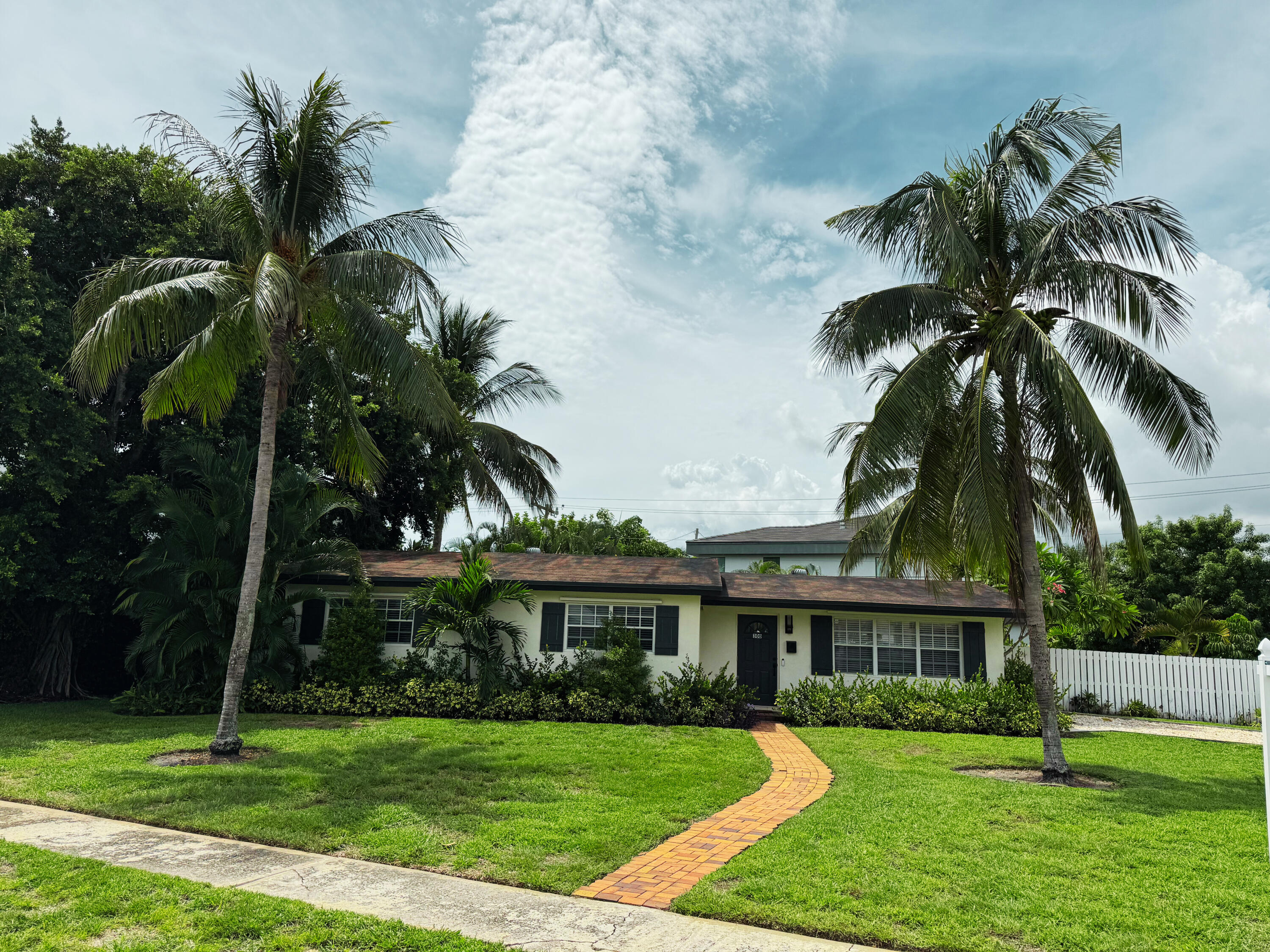 a front view of a house with a garden