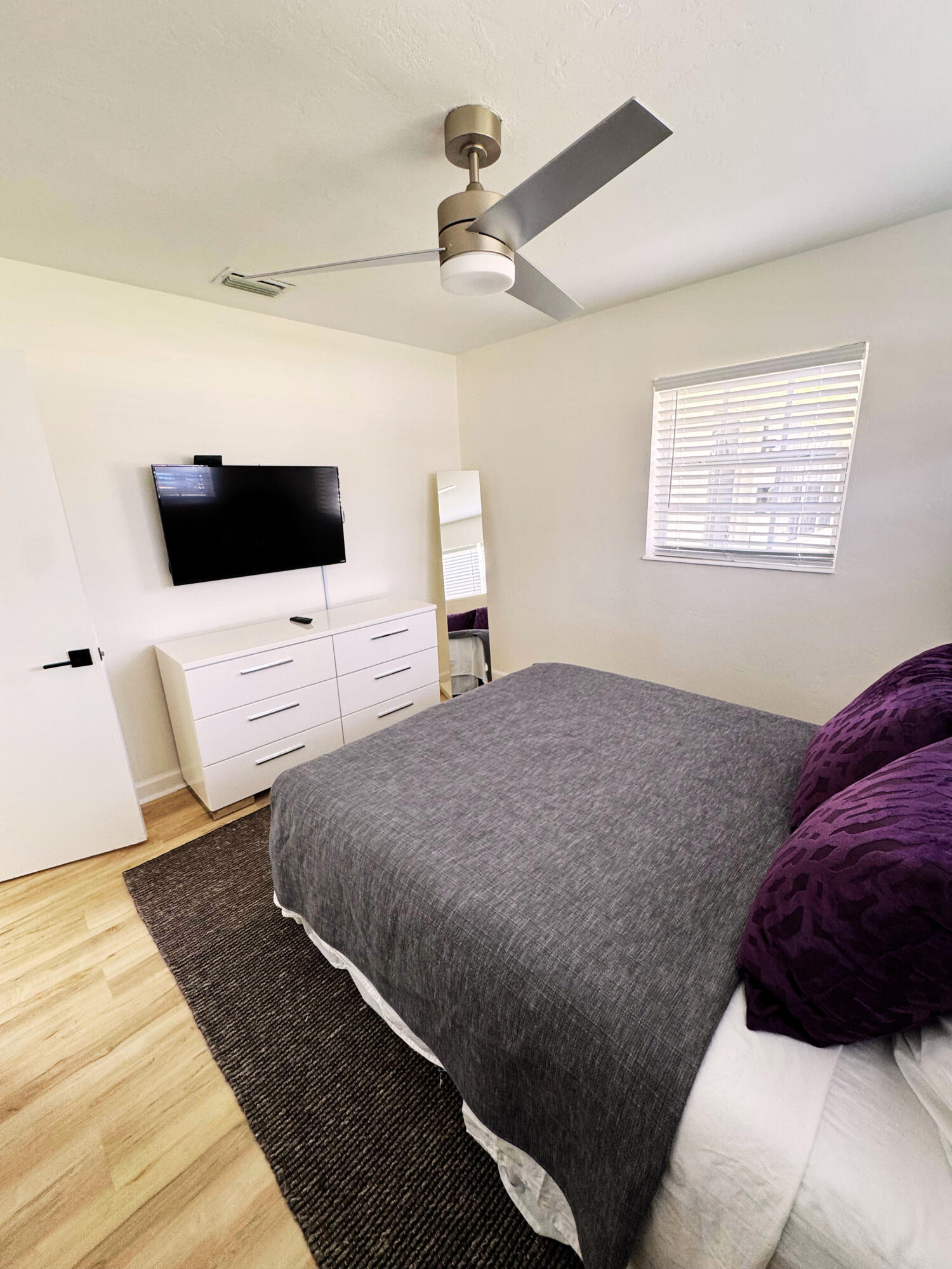 300 Northeast 7th Street Boca Raton, FL 33432 - Photo 7 of 16 a bedroom with a bed and a flat screen tv