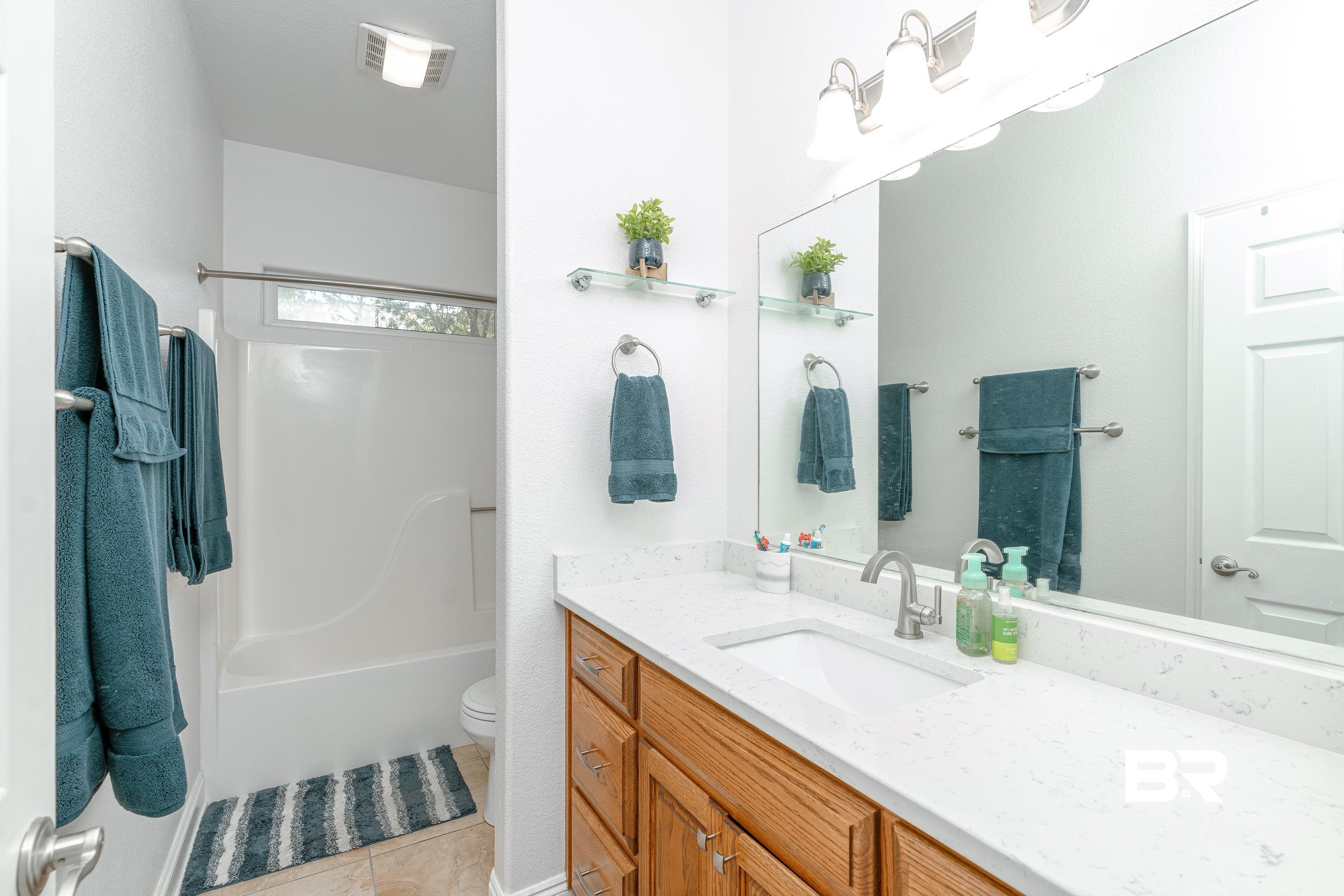 302 Bristol Way Foley, AL 36535 - Photo 23 of 51 Full bathroom featuring bathing tub / shower combination, vanity, toilet, and tile patterned floors