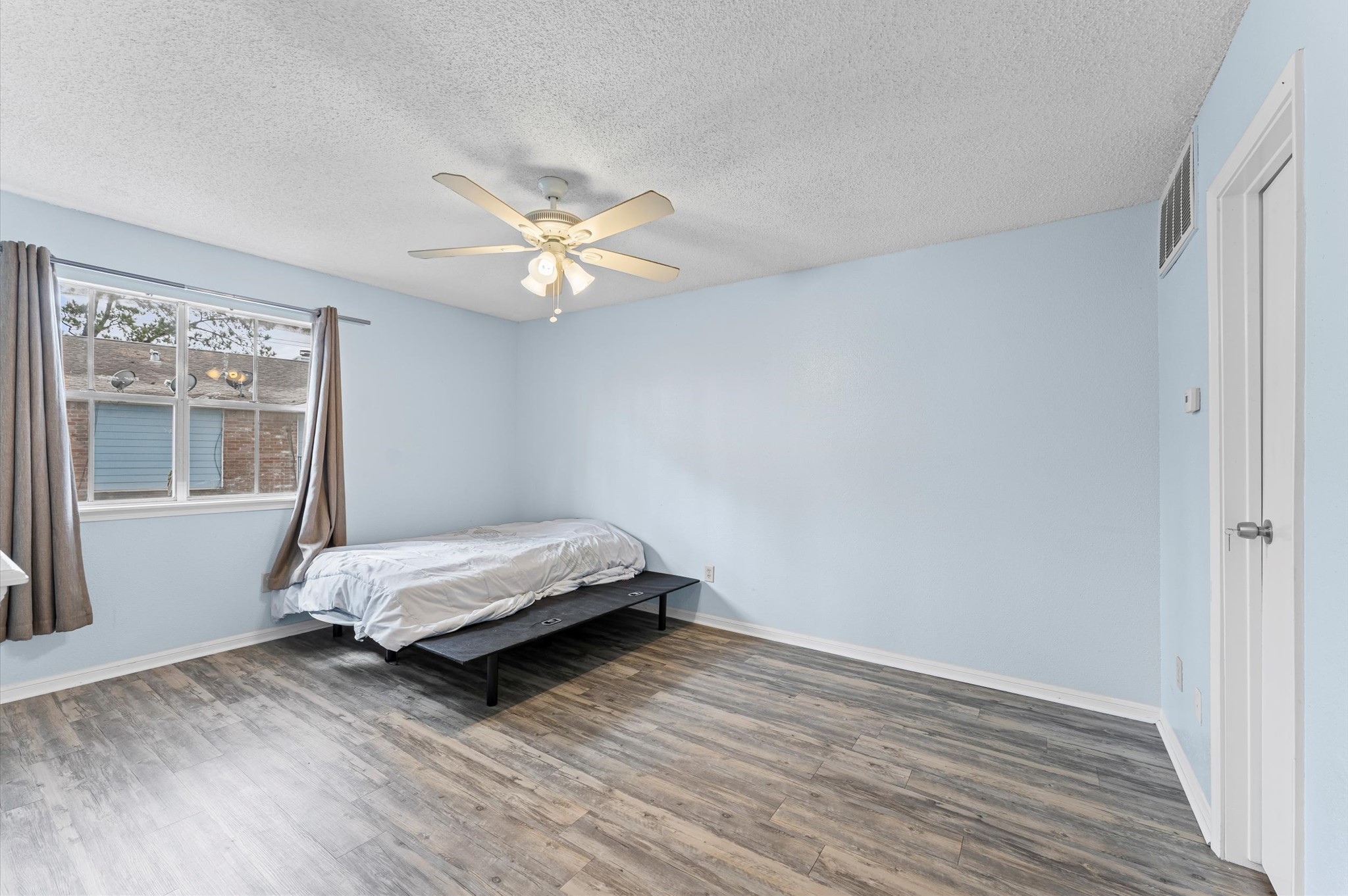 7402 Alabonson Road, Unit 303 Houston, TX 77088 - Photo 12 of 20 a bedroom with a bed and a window