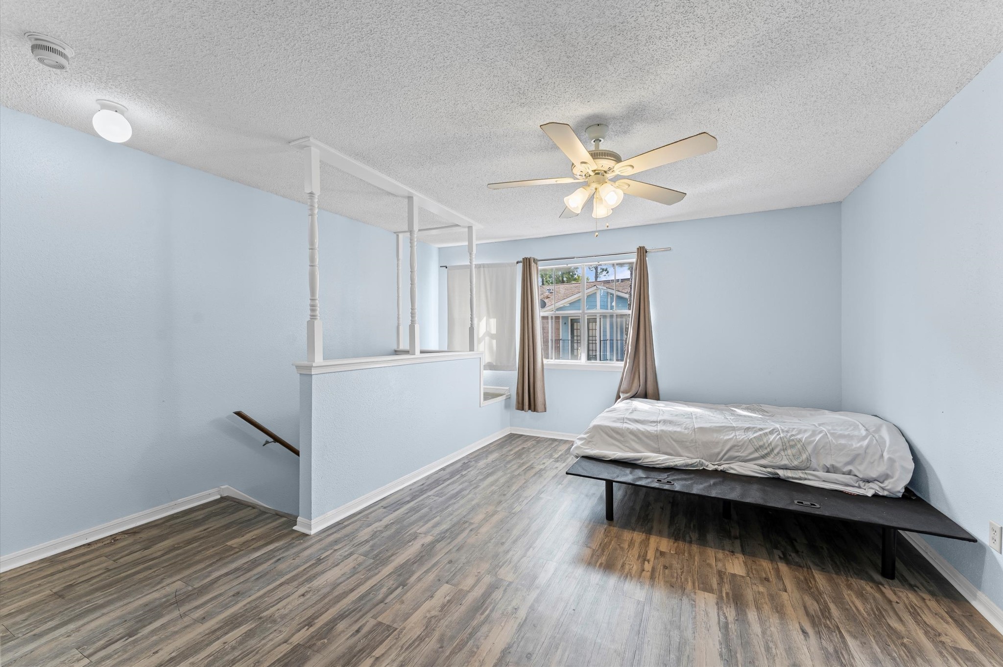 7402 Alabonson Road, Unit 303 Houston, TX 77088 - Photo 13 of 20 a bedroom with a bed and a window