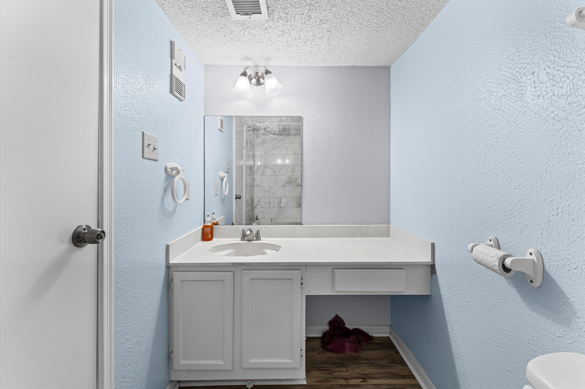 7402 Alabonson Road, Unit 303 Houston, TX 77088 - Photo 15 of 20 a bathroom with a sink and a mirror
