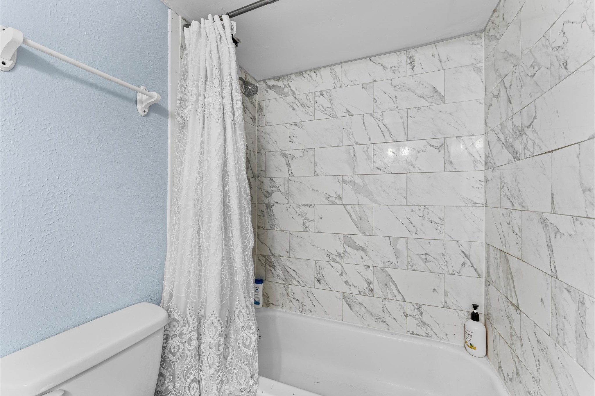 7402 Alabonson Road, Unit 303 Houston, TX 77088 - Photo 17 of 20 a bathroom with a shower and a toilet