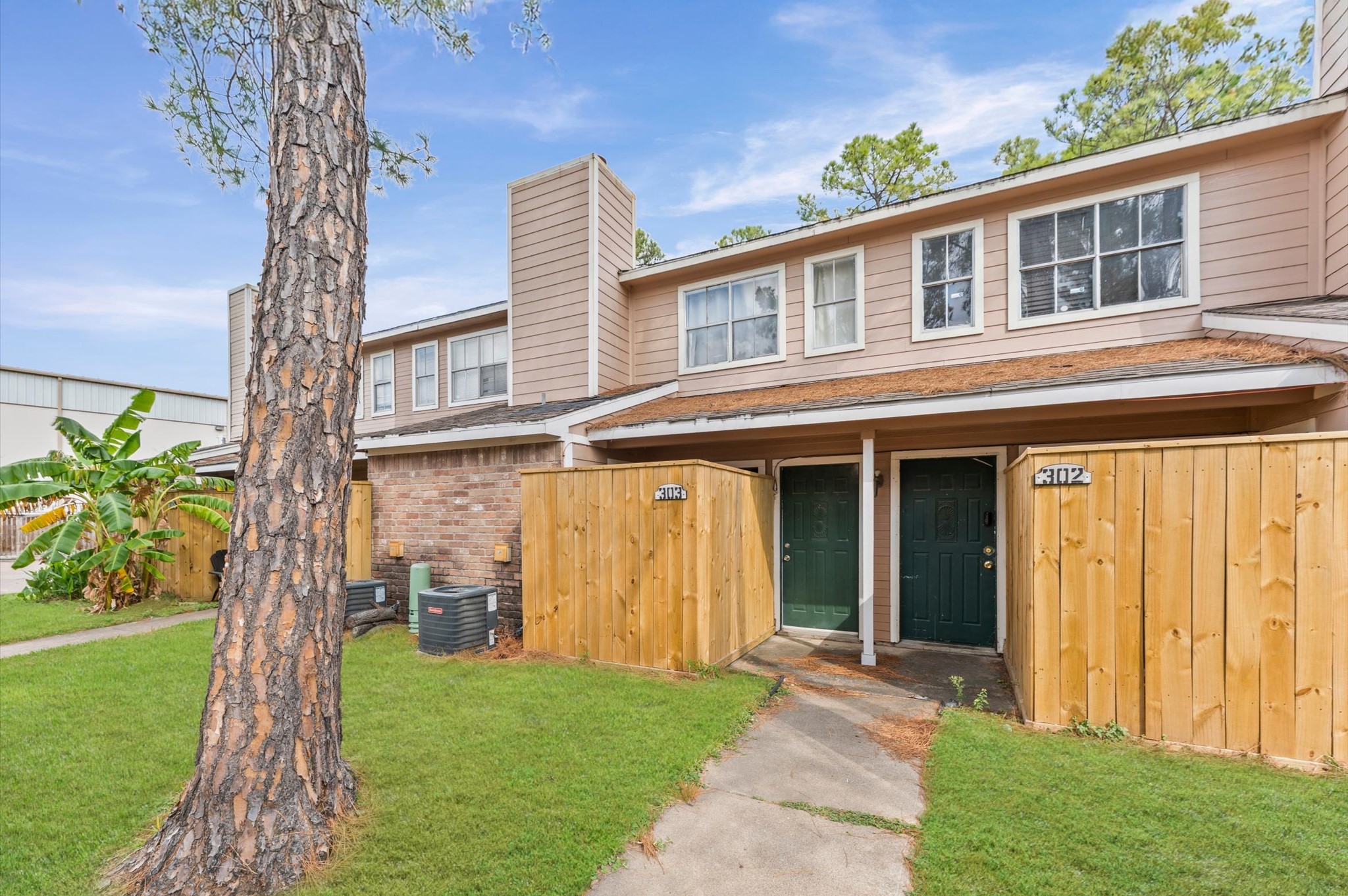 7402 Alabonson Road, Unit 303 Houston, TX 77088 - Photo 3 of 20 a front view of a house with a yard