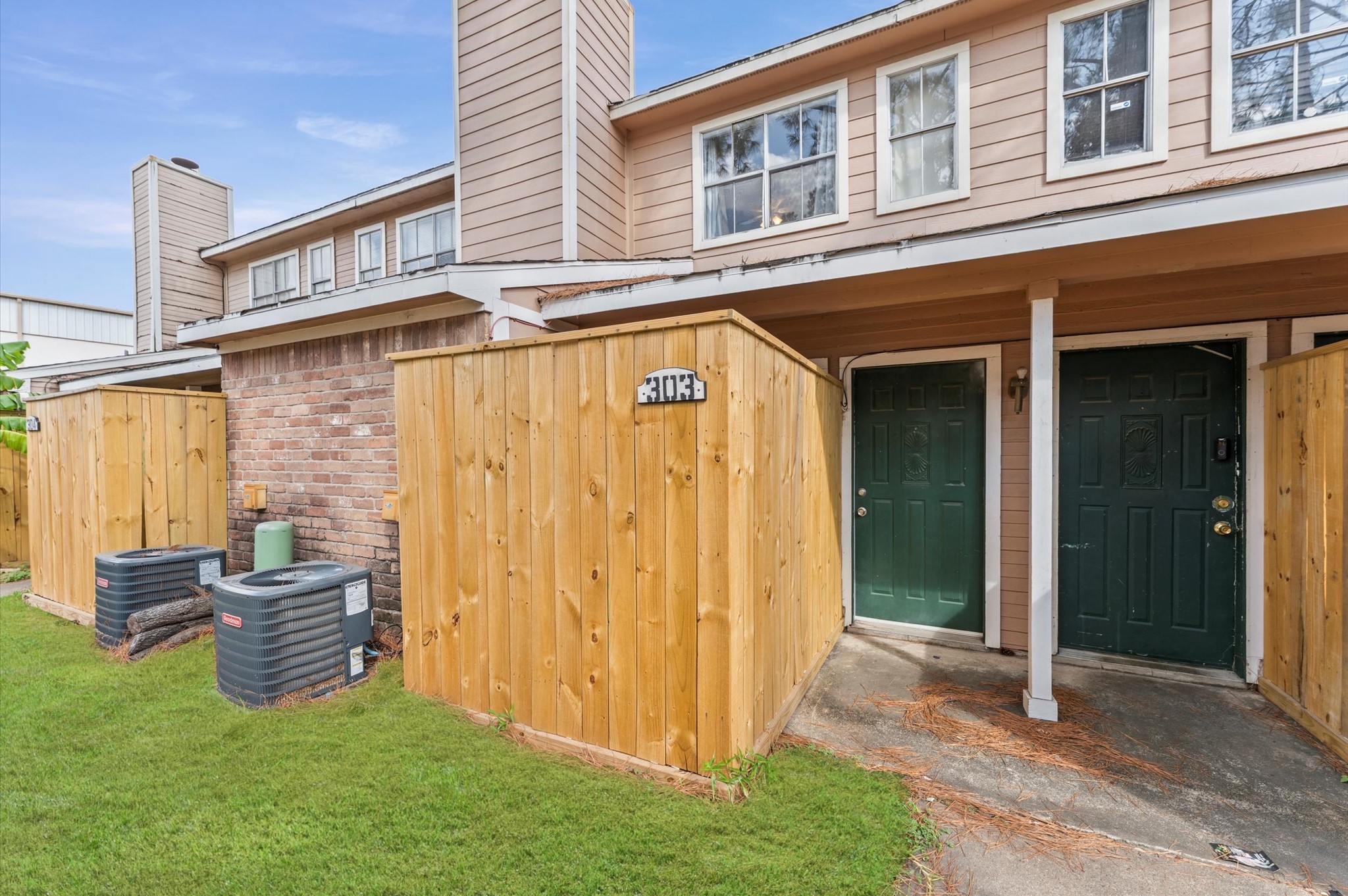 7402 Alabonson Road, Unit 303 Houston, TX 77088 - Photo 4 of 20 a view of a house with brick walls and a yard
