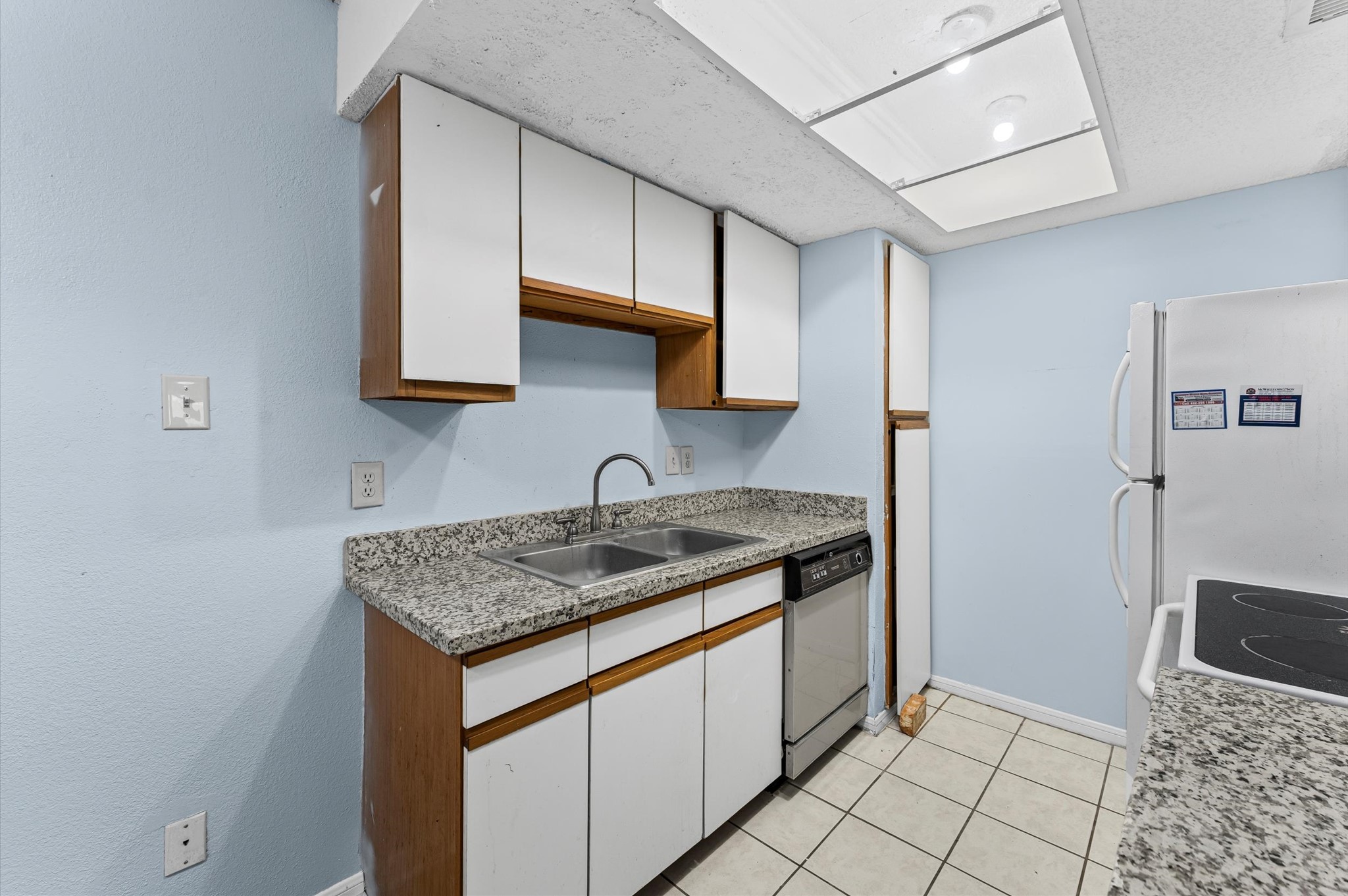 7402 Alabonson Road, Unit 303 Houston, TX 77088 - Photo 8 of 20 a kitchen with stainless steel appliances granite countertop a sink stove and cabinets
