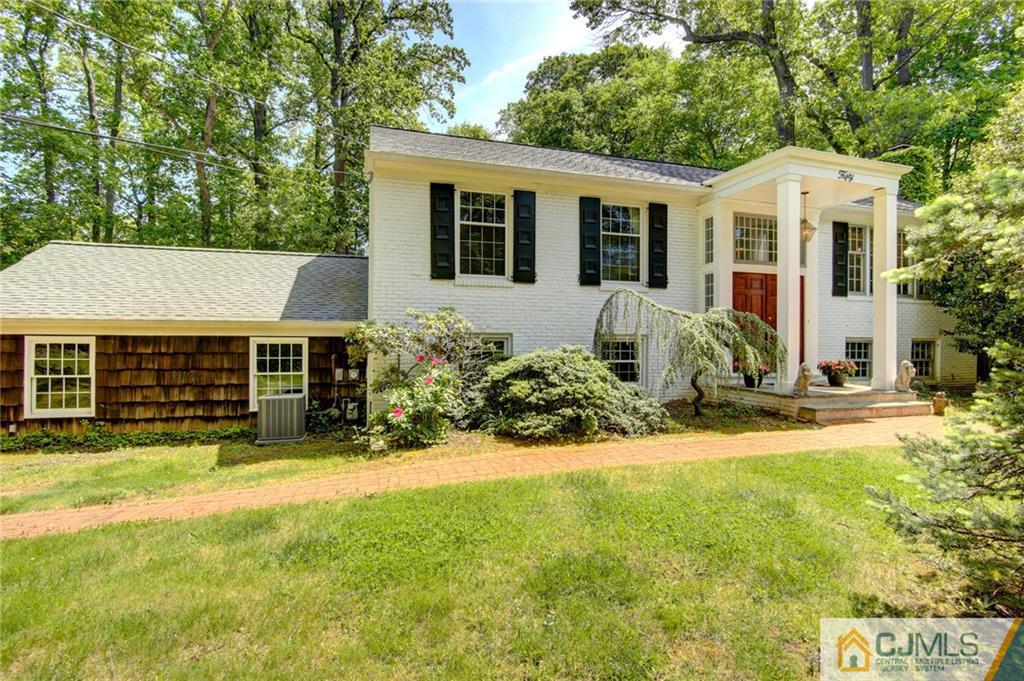 50 Wallace Road Middletown, NJ 07748 - Photo 2 of 24 a view of a house with a yard and lawn chairs with plants