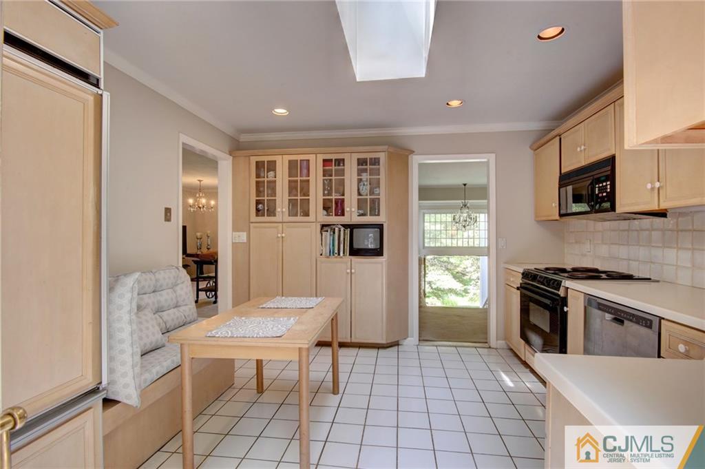 50 Wallace Road Middletown, NJ 07748 - Photo 11 of 24 a open kitchen with stainless steel appliances granite countertop a stove top oven a sink dishwasher and a refrigerator with wooden floor