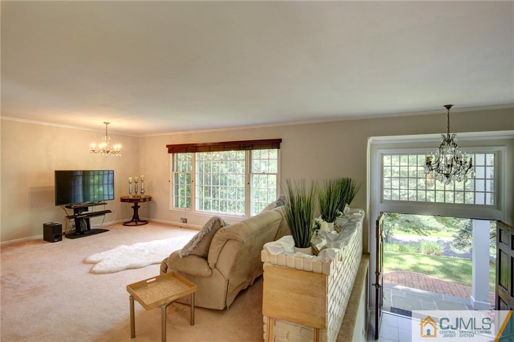 50 Wallace Road Middletown, NJ 07748 - Photo 15 of 24 a living room with furniture and a flat screen tv